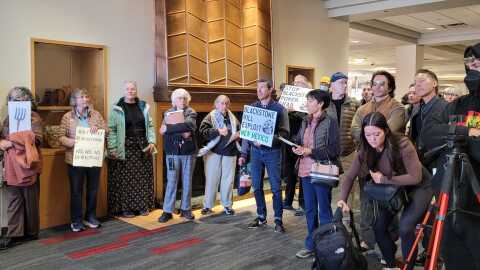 Protesters outside a NM Public Regulation Commission meeting February 17 at the University of New Mexico. The PRC was seeking public input on a controversial deal between private equity firm Blackstone Infrastructure and the Public Service Company of New Mexico's parent company, TXNM.