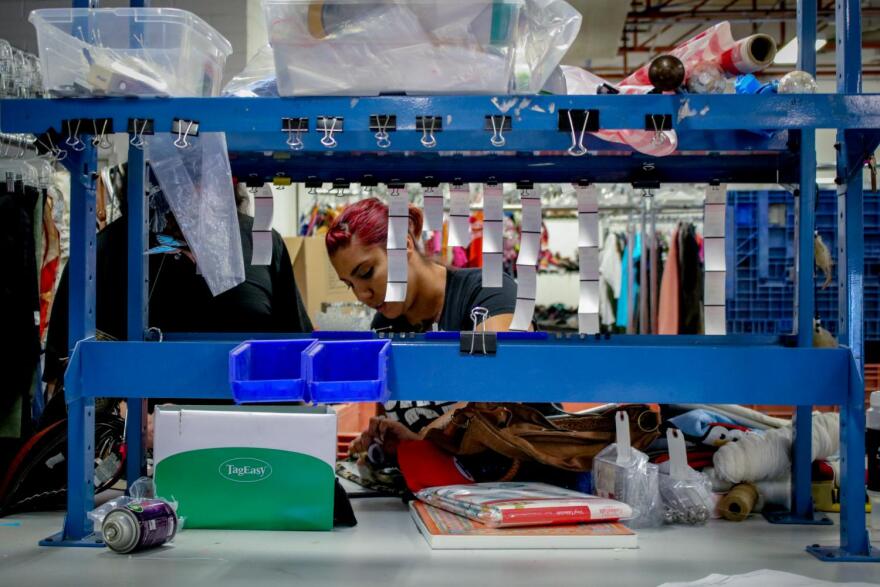 Employees sort and price items that will go up for sale in-store or online. 
