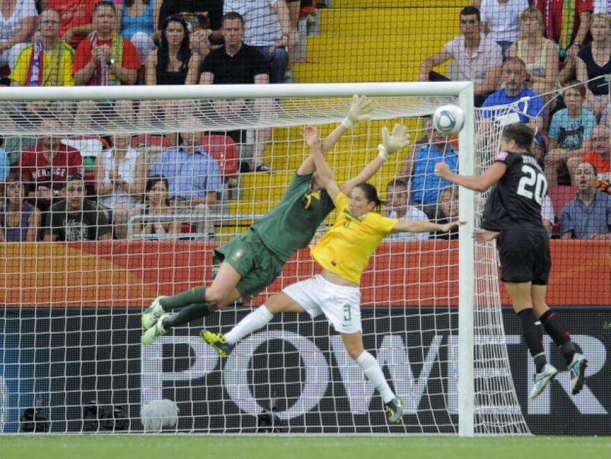 U.S. forward Abby Wambach heads in the equalizer past Brazil's defender Daiane and goalkeeper Andreia Sunday in Dresden.