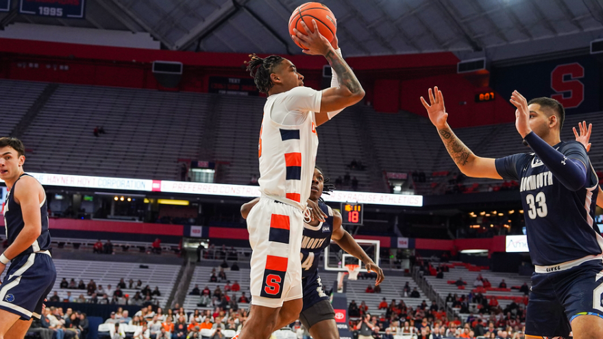 Syracuse guard Judah Mintz (white) elevates for a shot against Monmouth.