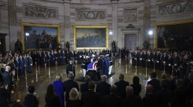 An Armed Forces Body Bearer Team places the flag-draped casket of Sen. Lindsey Graham of South Carolina, in the Rotunda of the U.S. Capitol, Tuesday, July 28, 2026, in Washington. (AP Photo/Allison Robbert)