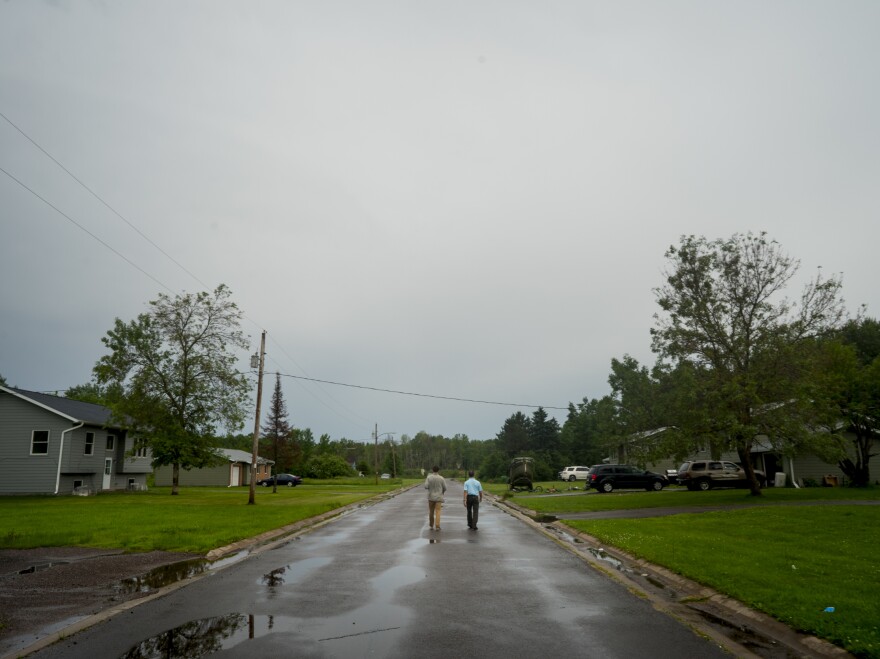 James Rees, left, and Nicholas Pinter of the University of California, Davis, gather housing data in the town of Odanah, Wis.