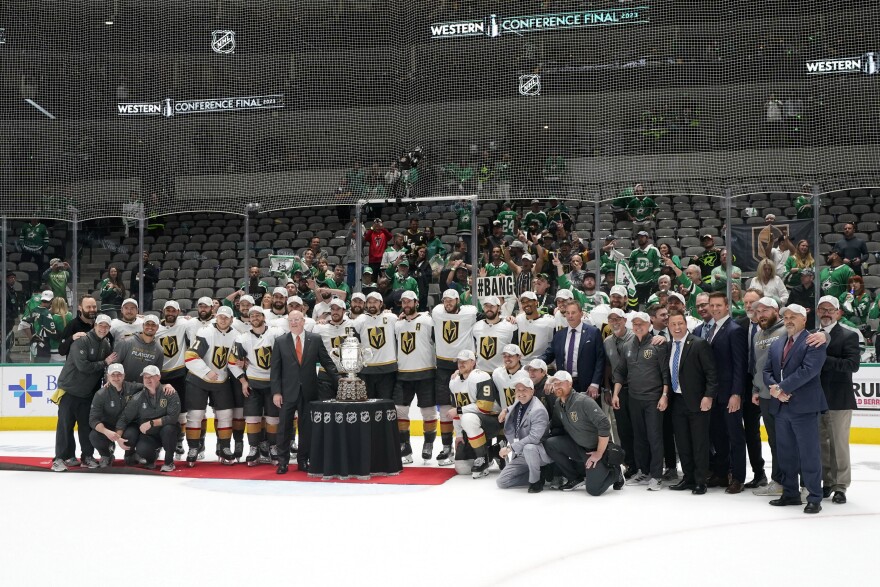 Bill Daly, third from front left, deputy commissioner of the NHL, presents the trophy to the Vegas Golden Knights following the team's win over the Dallas Stars in Game 6 of the NHL hockey Stanley Cup Western Conference finals, Monday, May 29, 2023, in Dallas.
