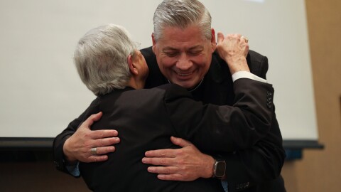 The Most Reverend Salvatore R. Matano embraces the Most Reverend John S. Bonnici as he introduces him and announces his resignation as Bishop of Rochester during a press conference Wednesday, Jan. 7, 2026, at the Bishop Hickey Conference Center. Bonnici then addressed the gathering.