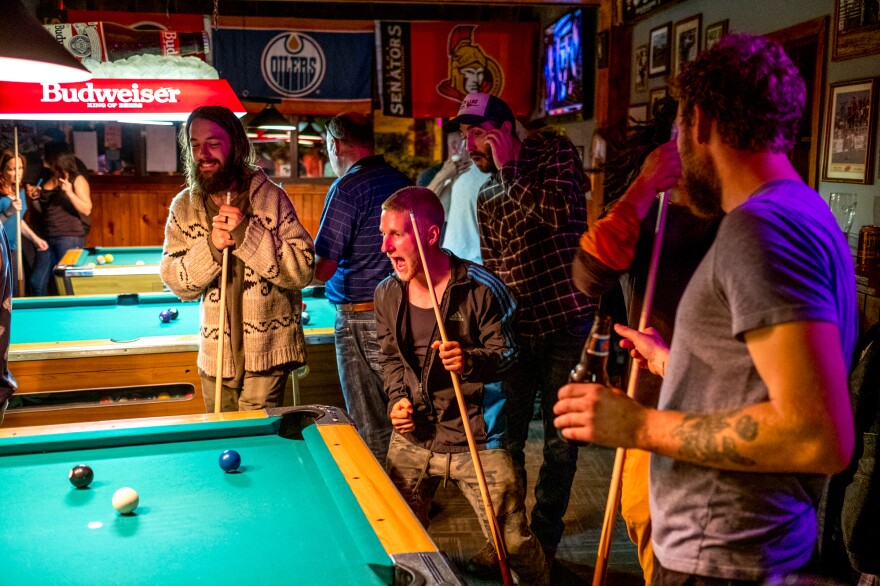 Planters play pool in a bar in central Alberta. Nights off are when planters bond and strengthen the social dynamics of the camp. For many planters the nights off are what keep them coming back year after year.