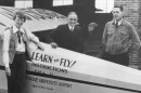 Amelia Earhart, l-r, Purdue University President Edward C. Elliott and Captain L. I. Aretz, standing next to an instructional plane at Purdue Airport, 1936.