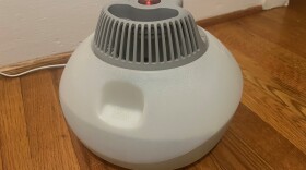A humidifier on a wooden floor