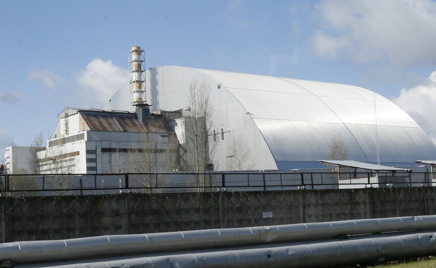 A shelter construction covers the exploded reactor at the Chernobyl nuclear plant, in Chernobyl,Ukraine, Tuesday, April 27, 2021. The Ukrainian authorities decided to use the deserted exclusion zone around the Chernobyl power plant to build a repository where Ukraine could store its nuclear waste for the next 100 years. (AP Photo/Efrem Lukatsky)