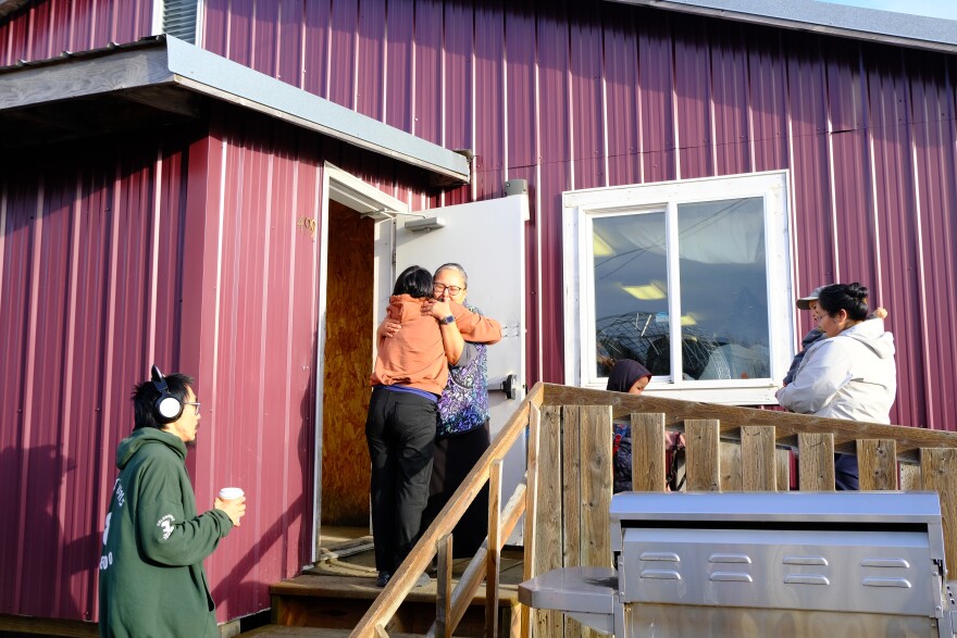 Family members displaced by ex-typhoon Halong embrace at the Bethel Search and Rescue building in Bethel on Oct. 14, 2025.