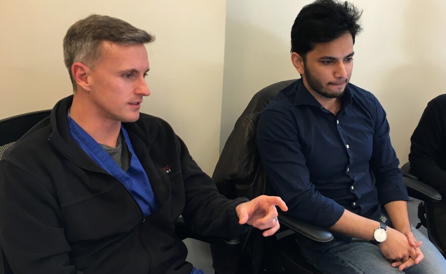 Dr. Matthew Lungren (left) and Pranav Rajpurkar attend a lab meeting where colleagues are testing an algorithm for tuberculosis diagnosis.