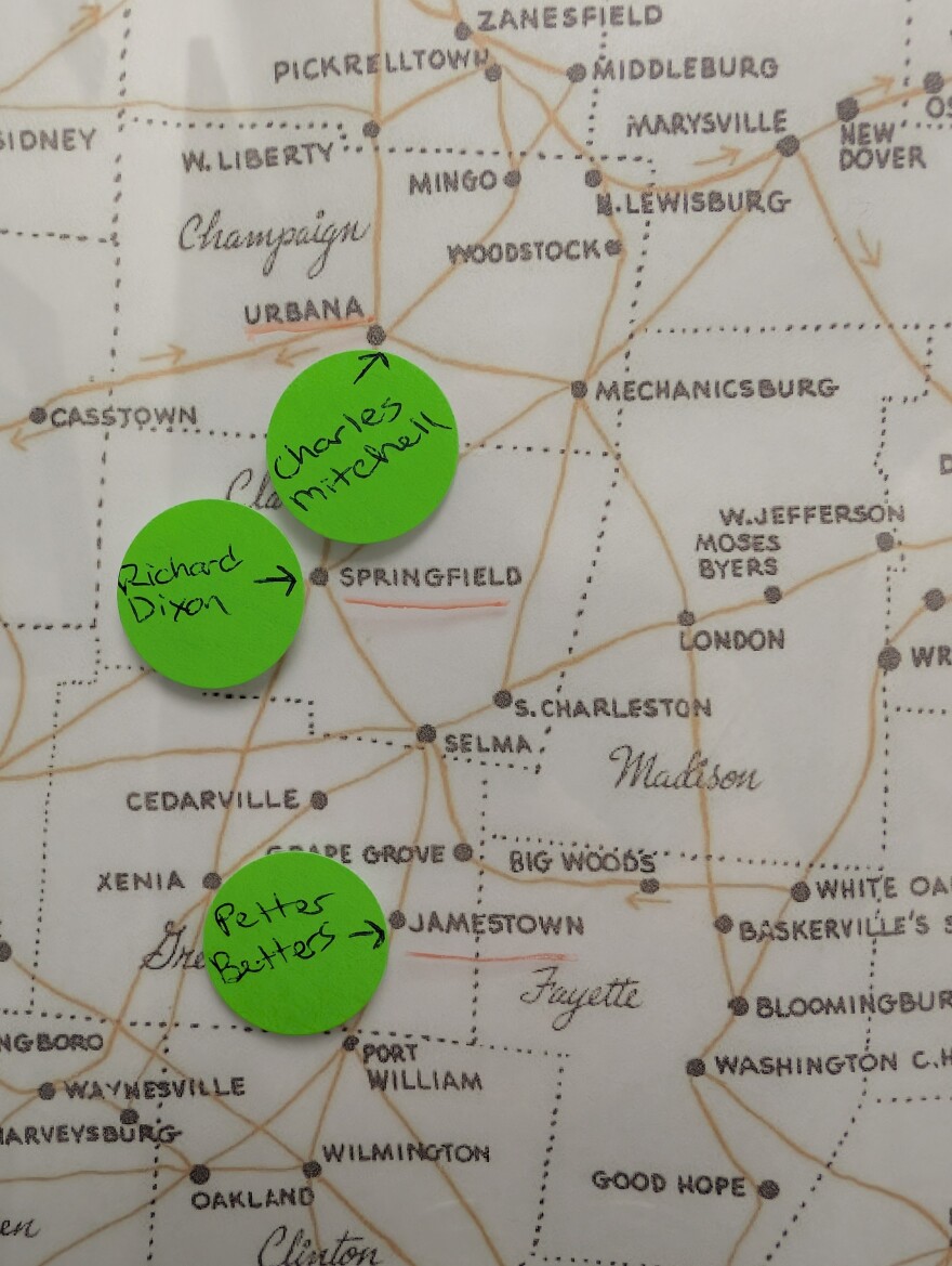 Green dots with the names of the men who were lynched mark the locations on a map. 