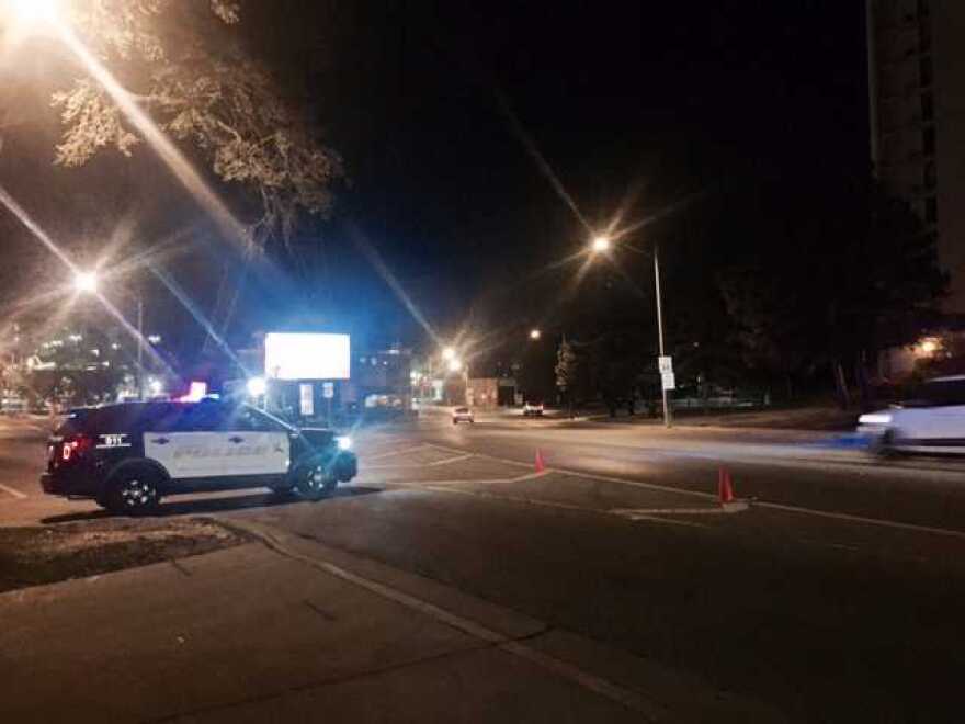 Squad car with lights flashing blocking entrance to the 500 block of north Center in downtown Bloomington.