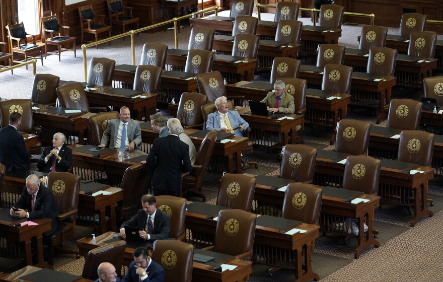 Empty seats are seen in the House Chamber at the Texas Capitol, Tuesday, July 13, 2021, in Austin, Texas. Texas Democrats left the state to block sweeping new election laws, while Republican Gov. Greg Abbott threatened them with arrest the moment they return.