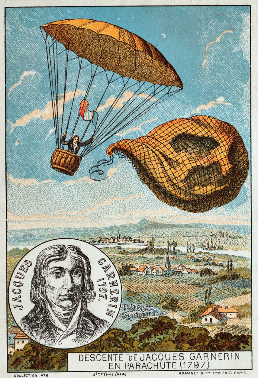 A drawing shows a man descending in a parachute over a European countryside.
