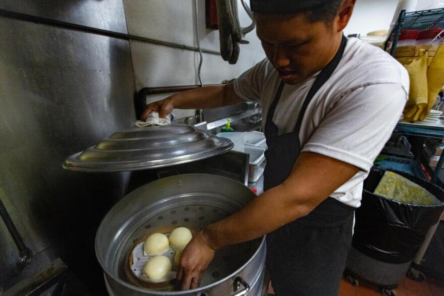 Chef Laurence Louie places bao into a steamer at Rubato in Quincy. (Jesse Costa/WBUR)