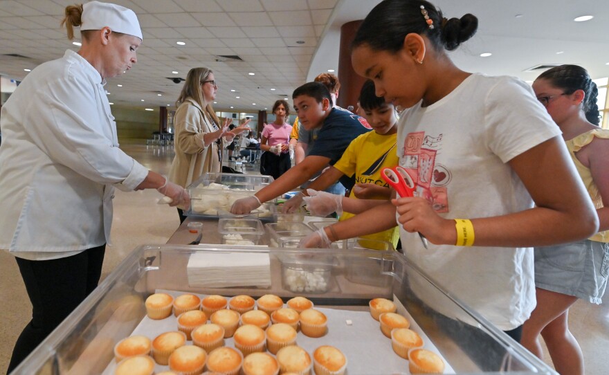 Students in the career camp at Scranton High School gather tools to make cupcakes.