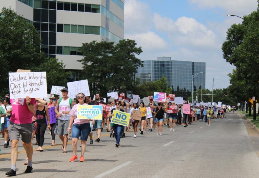 About a thousand people march south on Main Street in downtown Wichita for abortion rights. Kylie Cameron/KMUW