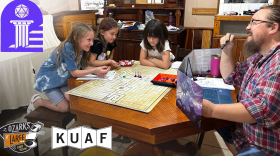 Evan McDonald, founder of Ozark Dice & Destiny, guides a group of campers through a dungeon.