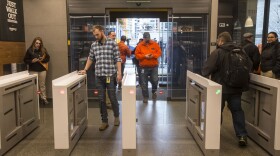 Shoppers enter and check out with purchases at the Amazon Go, on Jan. 22, 2018 in Seattle. After more than a year in beta, Amazon opened the cashierless store to the public. (Stephen Brashear/Getty Images)
