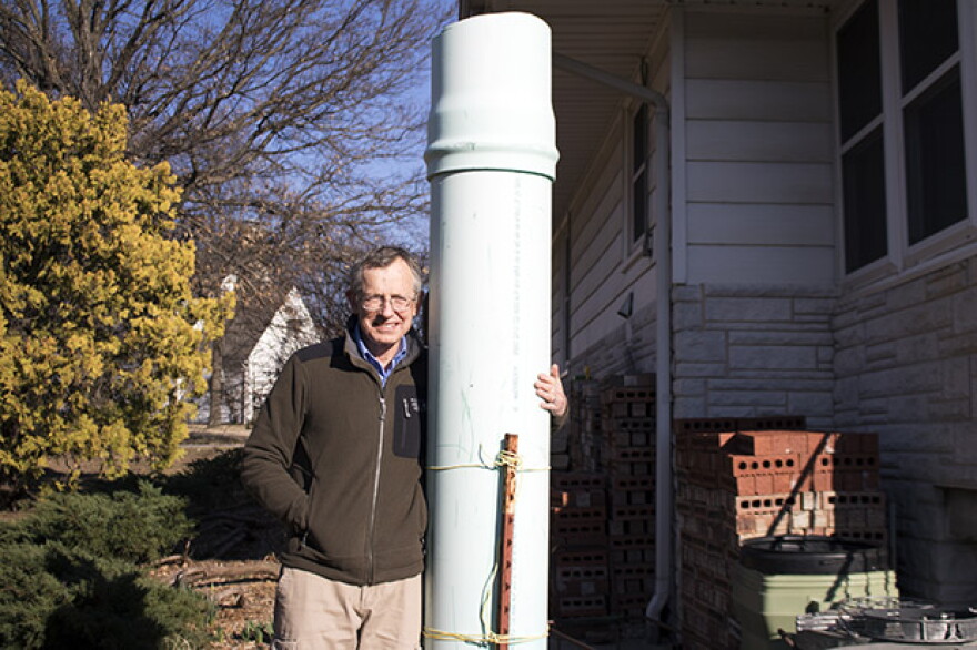 Jack Romine stands near a makeshift chimney state inspectors installed over an abandoned, leaky well that was discovered near his home in Bartlesville, Okla.