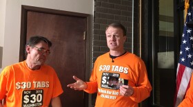 Professional initiative sponsor Tim Eyman holds a photograph from his first successful $30 car tabs initiative in 1999. Eyman says he has collected almost enough signatures to qualify a 2019 car tabs rollback initiative to the 2019 Legislature.