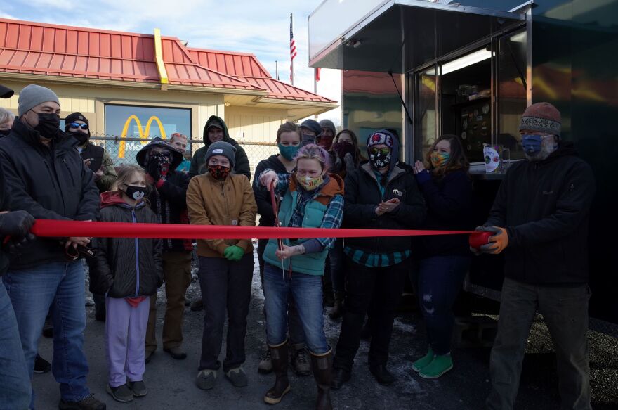 Diane Million cuts the ribbon for her new food truck business.