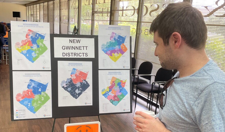 A man looks at newly drawn congressional districts for Gwinnett County, Ga., at a meeting of county Democrats this month.