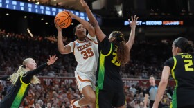 Texas forward Madison Booker drives to the basket against Oregon forward Ehis Etute.