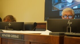 Sen. Mike Gierau sitting behind a desk in Cheyenne on Dec. 1, 2025.