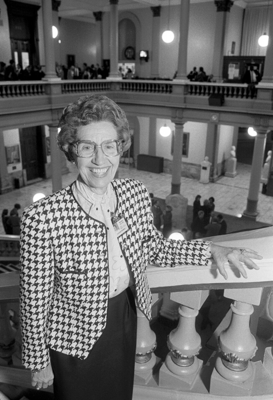 Description: Louise McBee Portrait of Louise McBee standing on steps inside the Georgia State Capital Building Rotunda. 