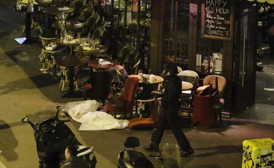 A white sheet covers a victim outside a restaurant in central Paris.