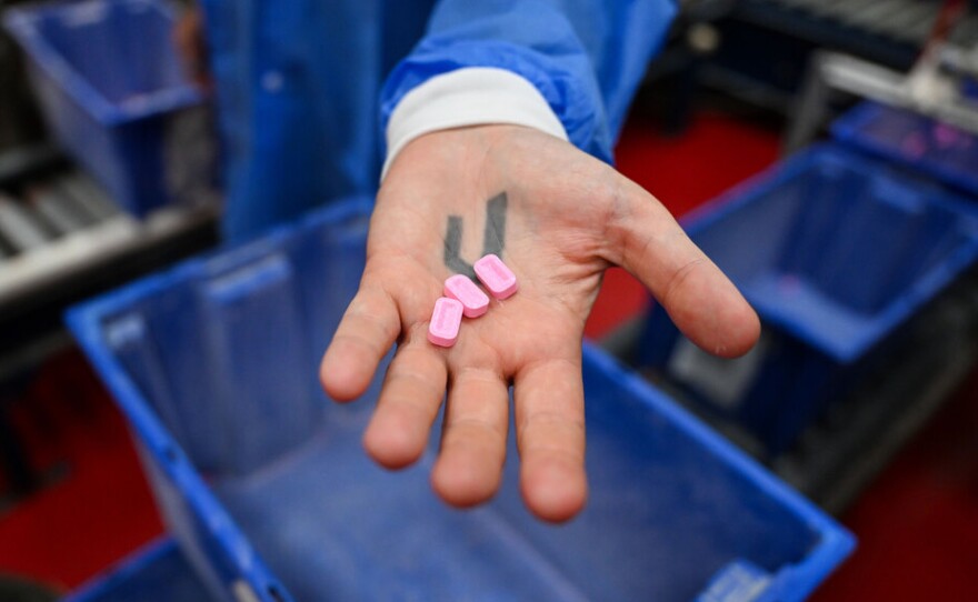 Host of Audacious, Chion Wolf recieves a freshly warm pez inside of the Pez Factory on July 29, 2025 in Orange, CT. (Ayannah Brown/Connecticut Public)