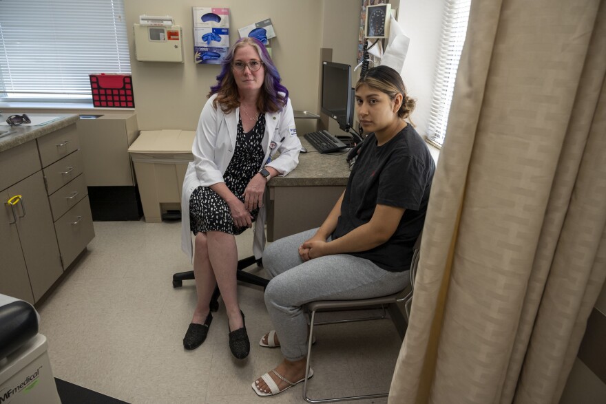 Francesca Turner (left), an OB/GYN at Broadlawns Medical Center in Des Moines, sits next to her patient Kimbrly Orea Badillo after her first postpartum appointment. Orea Badillo says she relies on Medicaid to be able to cover things like pain medication for her C-section and contraceptives following the birth of her second child in May.