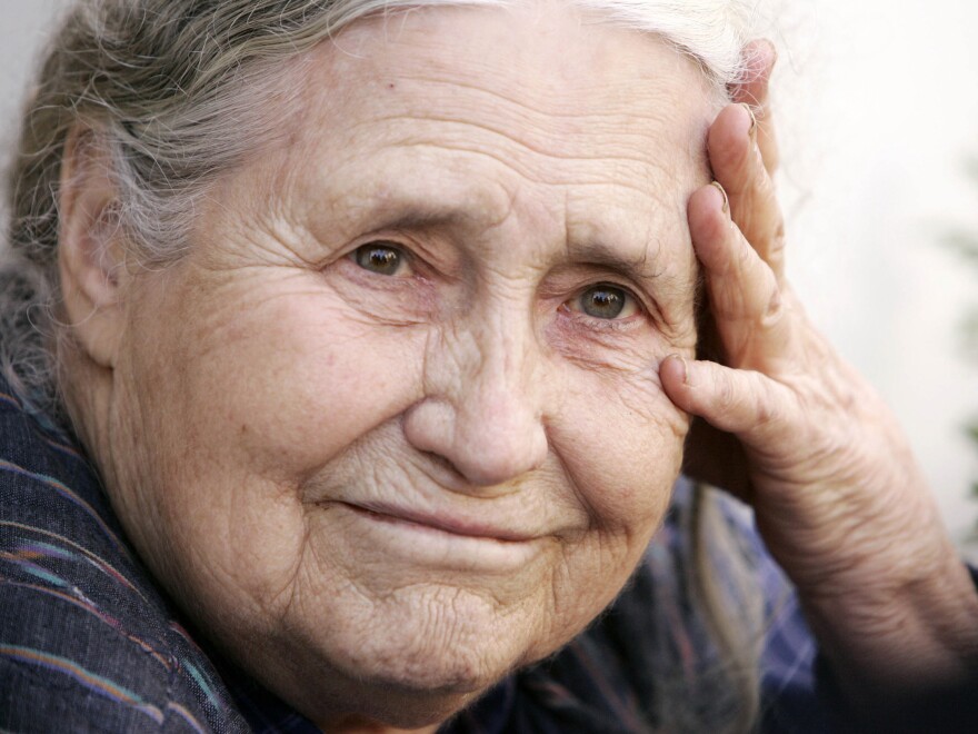 Sitting on the steps outside her London home, Doris Lessing learns from reporters that she won the 2007 Nobel Prize in Literature.