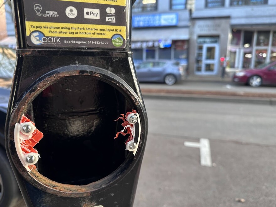 Old parking meter with scraps of plastic and metal.