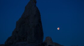 A lunar eclipse viewed from California's Trona Pinnacles Desert National Conservation Area. Scientists believe there may be more moons in the galaxy than planets.