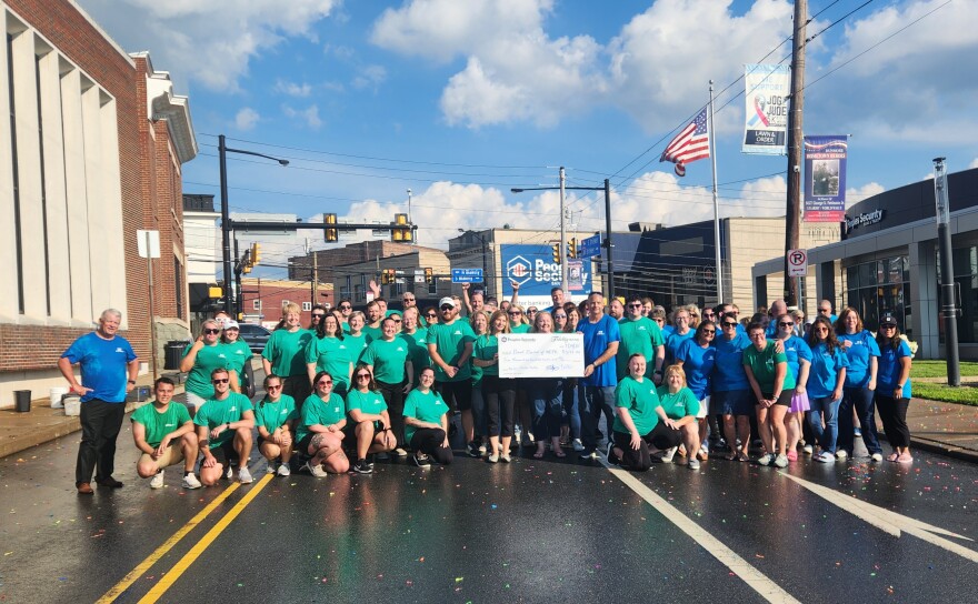 Employees of Fidelity Bank and Peoples Security Bank & Trust present a check for more than $3,100 to Bread Basket of NEPA.