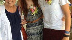 Jennifer Rambo (middle) and her wife, Kriston Seaton, (right) posing at a mass wedding reception in Eureka Springs in summer 2014, with their civil rights attorney, Cheryl Maples (left).