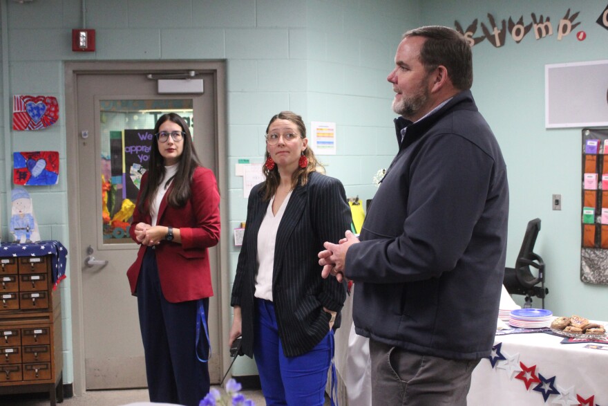 From left, Principal Hannah Dolphin, Assistant Principal Aubrie Ellis and Superintendent Clayton Holland talk with lawmakers at Mountain View Elementary School on Tuesday, Nov. 11, 2025 in Kenai, Alaska.