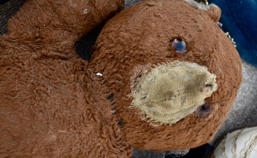 An old stuffed teddy bear at a yard sale participating in the US 12 Heritage Trail Garage Sale.