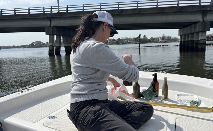 Lisa Renee Jennings with the Chesapeake Bay Foundation disposes of litter collected along the Lafayette River in Norfolk on March 27, 2026.