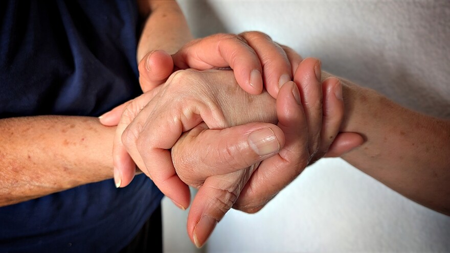 Amelia holds her daughter Raquel's hand.
