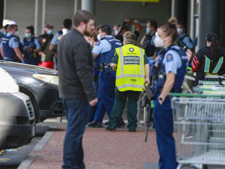 Police and ambulance staff attend a scene outside an Auckland supermarket, Friday, Sept. 3, 2021. New Zealand authorities said Friday they shot and killed a violent extremist after he entered a supermarket and stabbed and injured several shoppers. Prime Minister Jacinda Ardern described the incident as a terror attack. (Alex Burton/New Zealand Herald via AP)