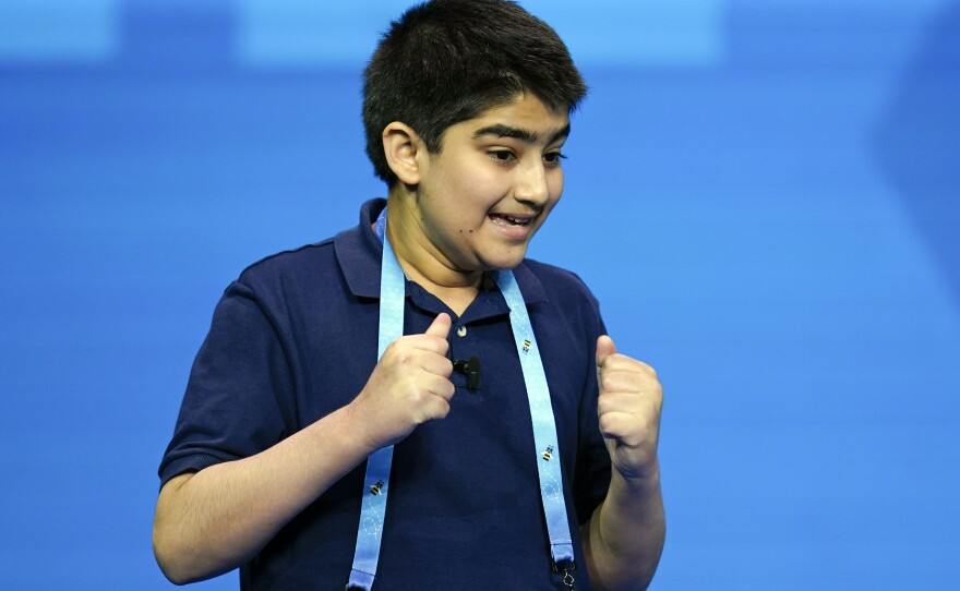 Dhroov Bharatia, 12, from Plano, Texas, reacts after correctly spelling a word during the finals.