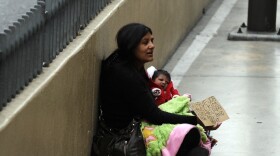 A woman begs for alms along the Las Vegas strip in Las Vegas, Nevada, on Nov. 11, 2011. U.S. unemployment edged down to 8.3 percent at the end of January. Employment levels are not equal among all demographics.