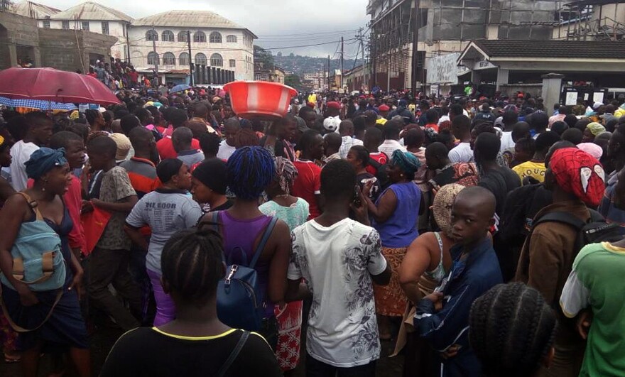 The Connaught Hospital morgue in Freetown was having trouble coping with the number of bodies. Outside, family members wait to identify their loved ones.