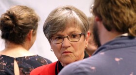 Kansas Governor Laura Kelly speaks to a person attending a press conference on Tuesday, May 14. Kelly is vetoing state lawmakers' latest attempt to pass tax cuts and will call them back to Topeka for a special session.