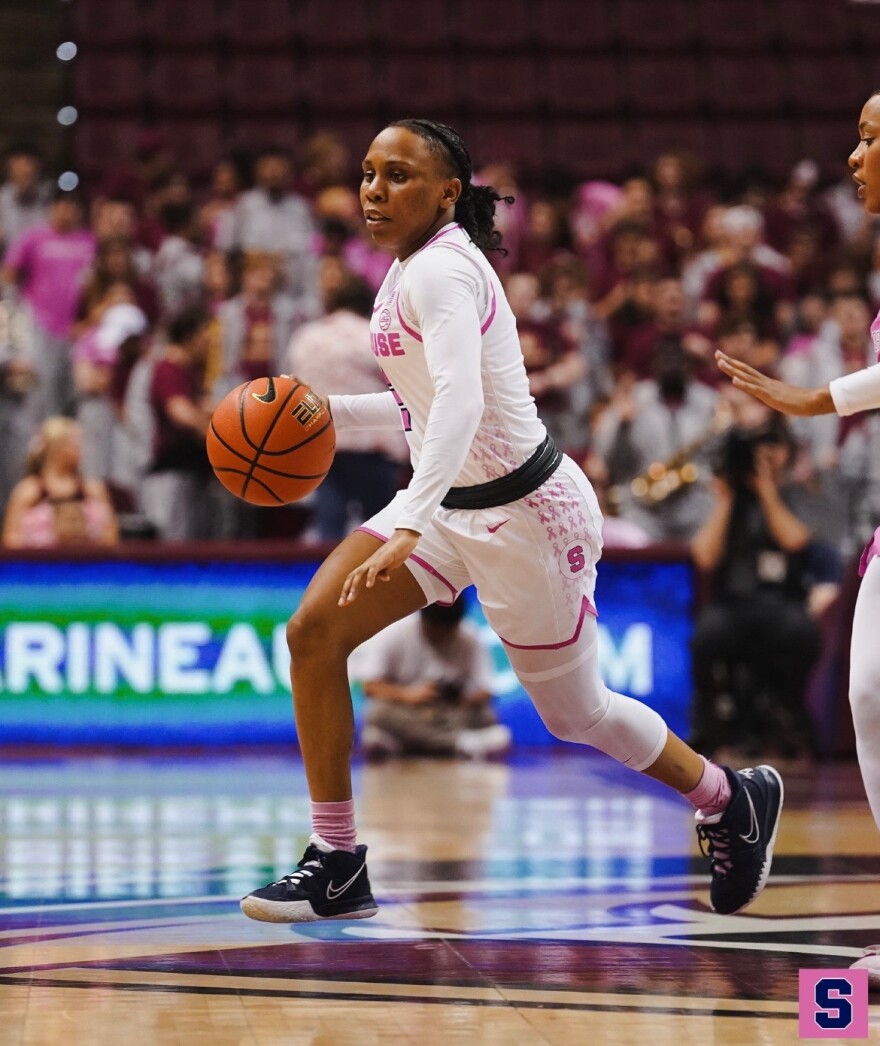 Dyaisha Fair (white #2) pushes the ball up the floor with her right hand against Florida State.