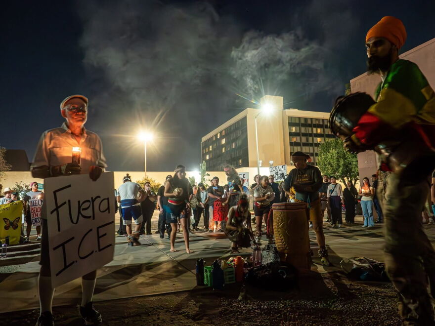 Dozens of people hold a vigil outside an immigration processing center in downtown Fresno, Calif. on Oct. 7, 2026.
