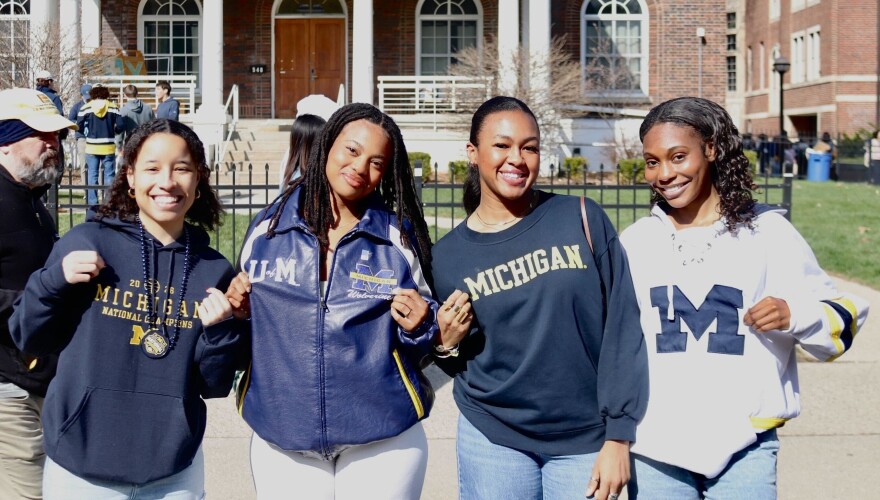 Michigan students (from left to right) Alex Giles, Abbi Hall, Kamryn Washington, and Milan Tillman show their school spirit in maize and blue gear.